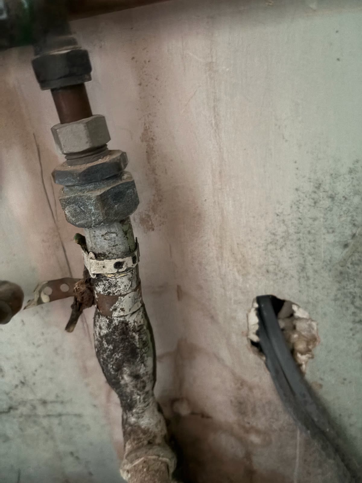 Leadlock adaptor between lead and copper pipework checked after a leak repair in Blaby