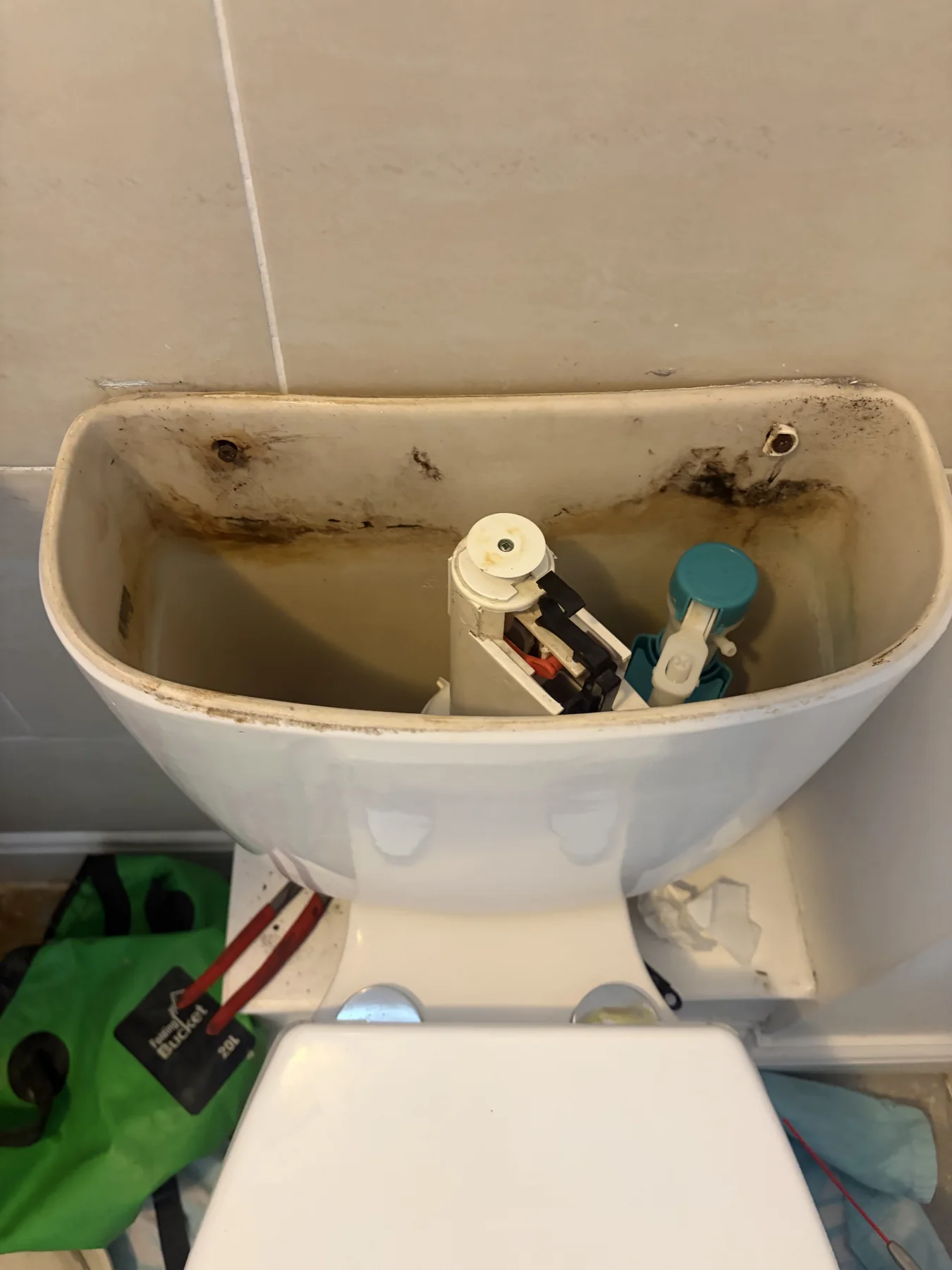 Old toilet cistern components before repair in Broughton Astley