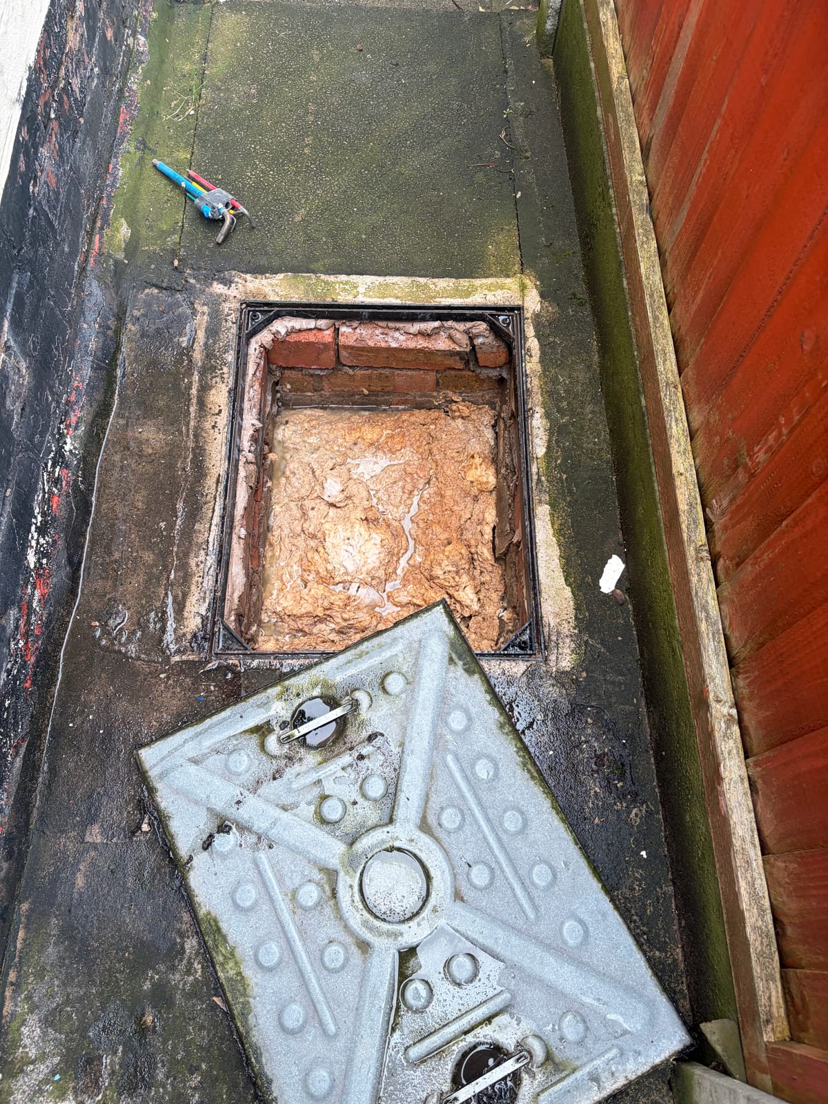 Blocked external manhole diagnosed during a toilet leak call-out in Earl Shilton