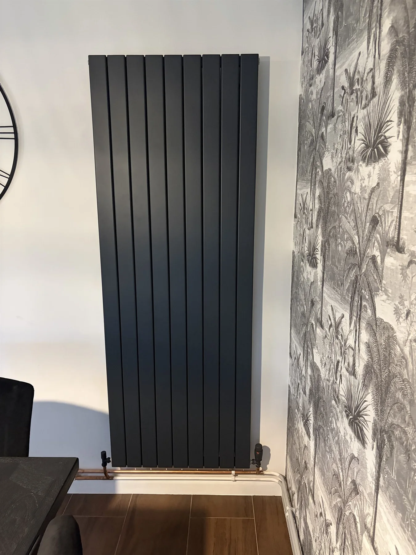 Tall black designer radiator with new copper pipework installed by AFS in Enderby