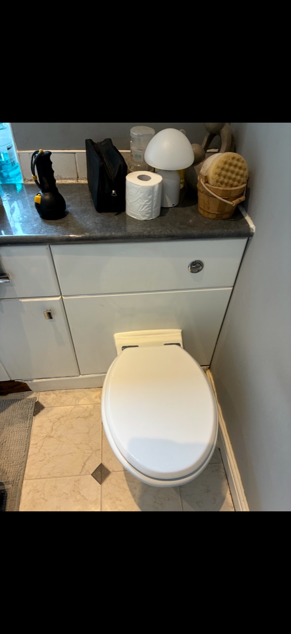 Completed toilet and vanity after a concealed cistern replacement in Hinckley