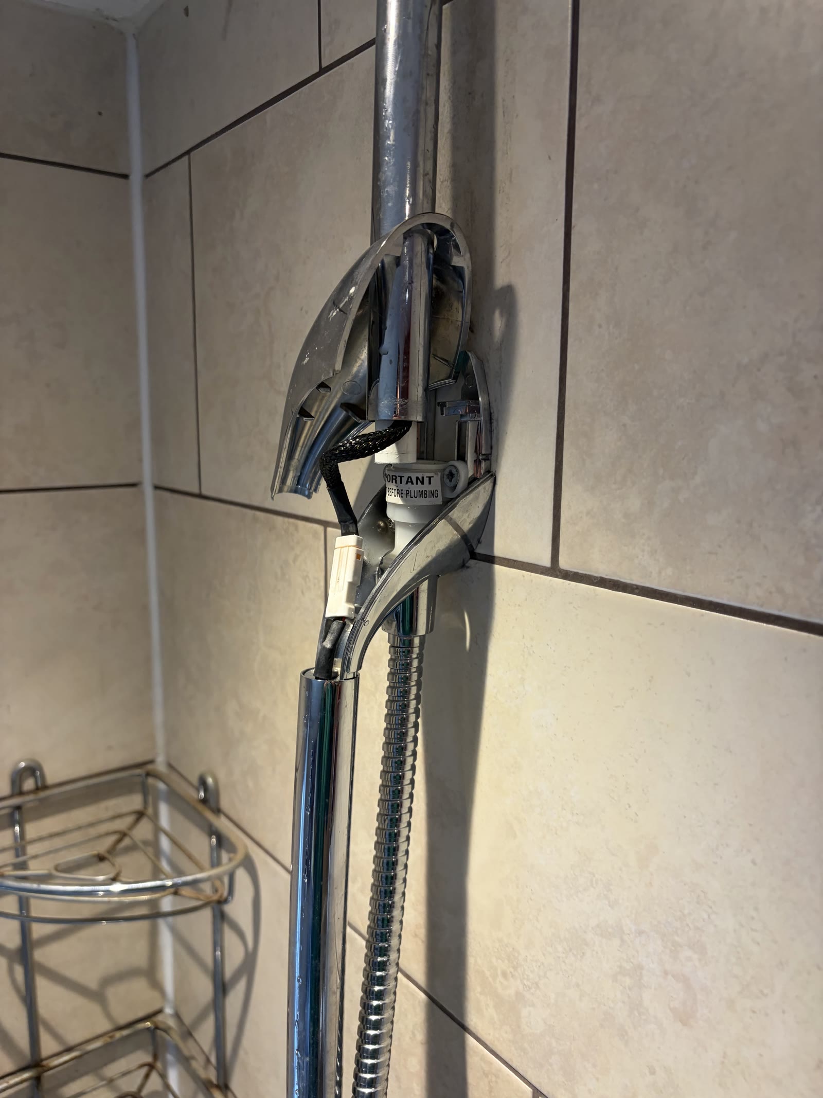 Shower pipe connection exposed during an emergency leak repair in Leicester Forest East
